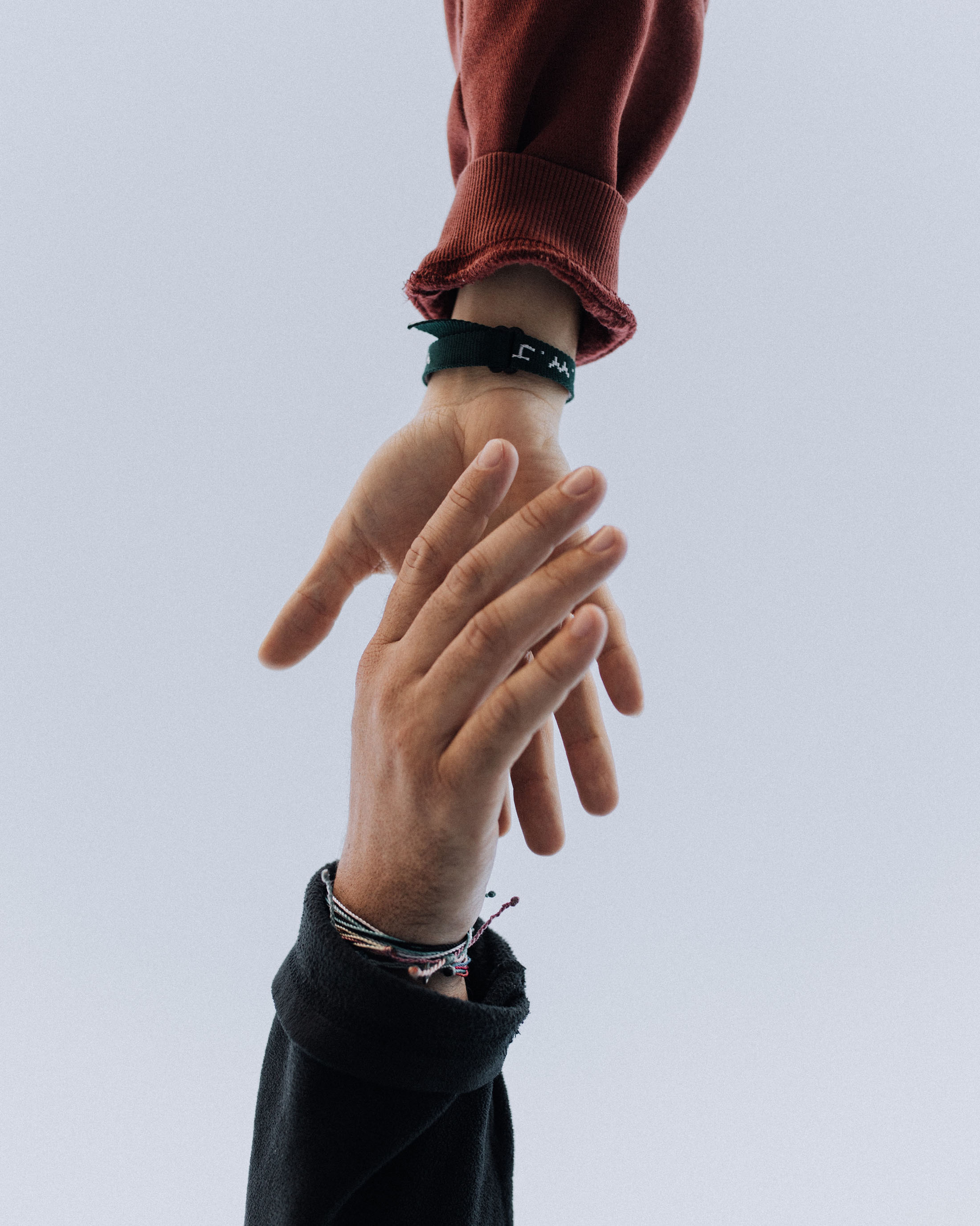 two hands reaching out help each other support
