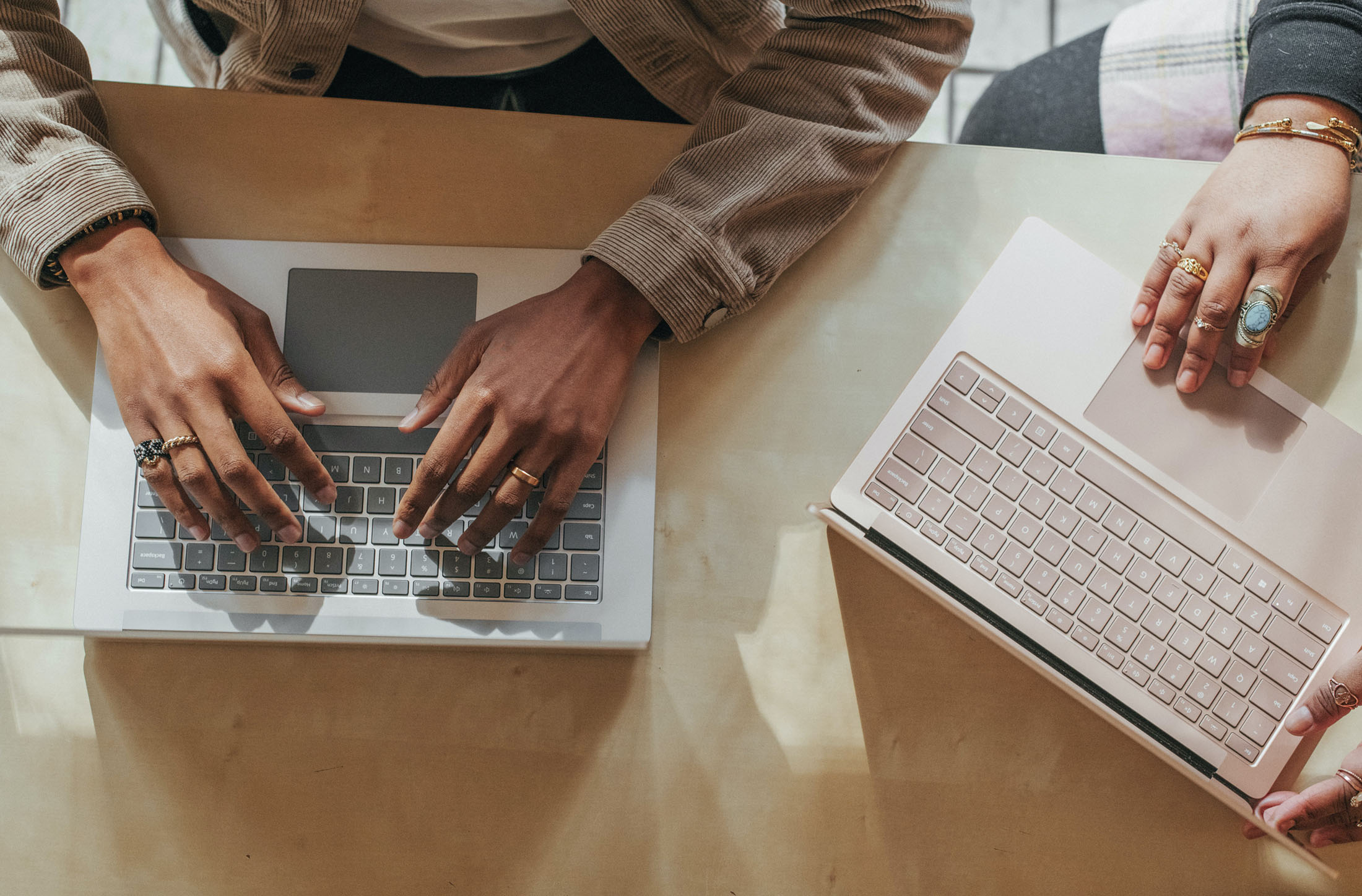 two professional business people working together on a project laptops women